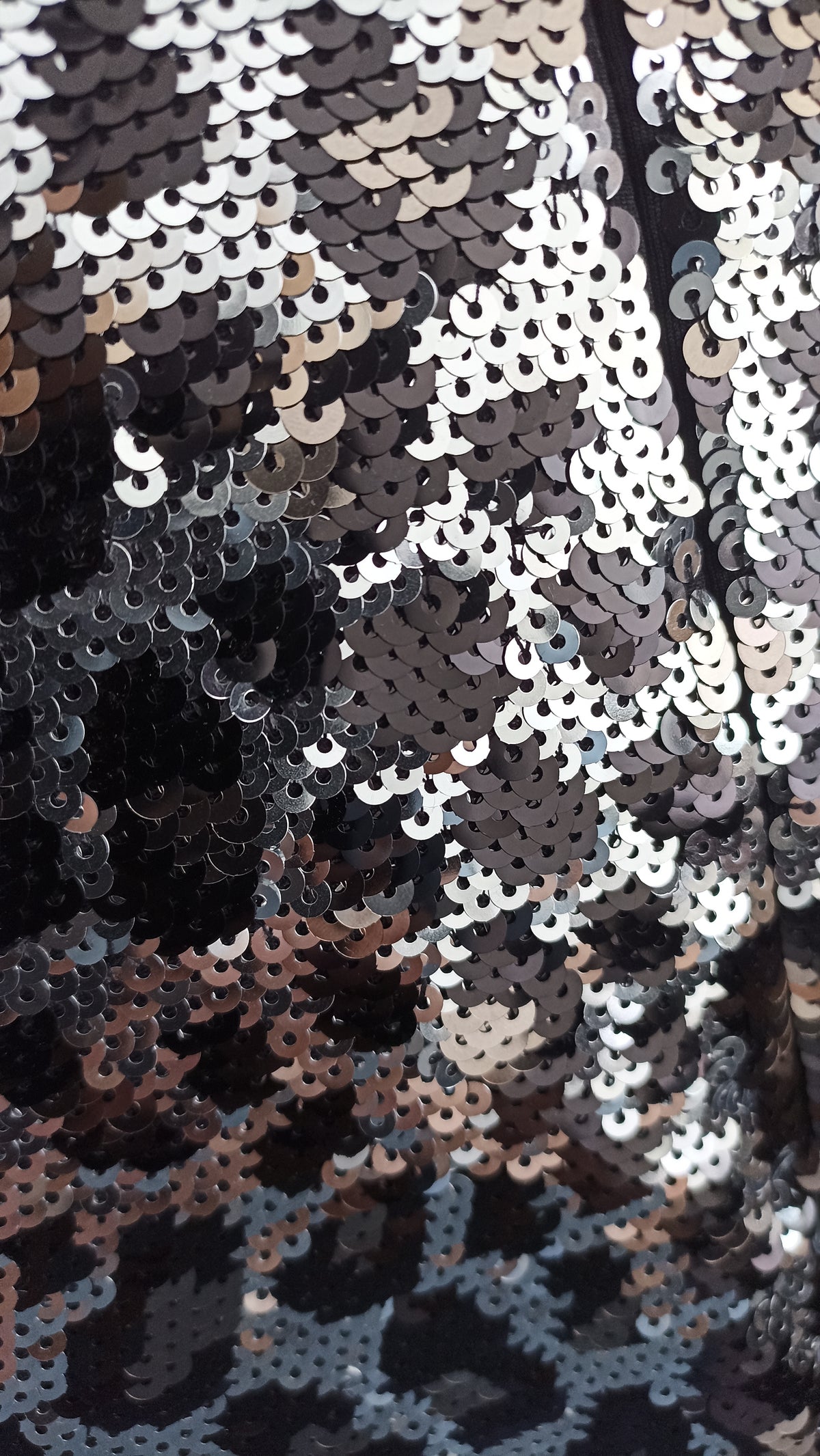 Close-up of silver, gunmetal and black sequins forming the animal-print pattern on the Michael Kors top.