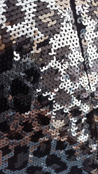 Close-up of silver, gunmetal and black sequins forming the animal-print pattern on the Michael Kors top.
