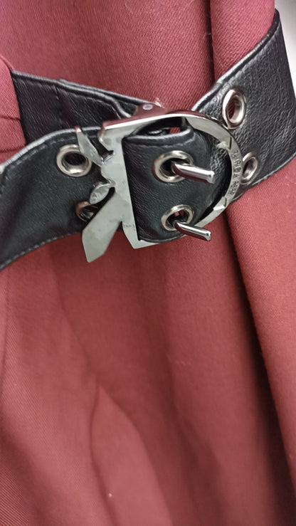 Close-up of the black waist strap with silver-tone buckle and eyelets on the burgundy Patrizia Pepe dress.