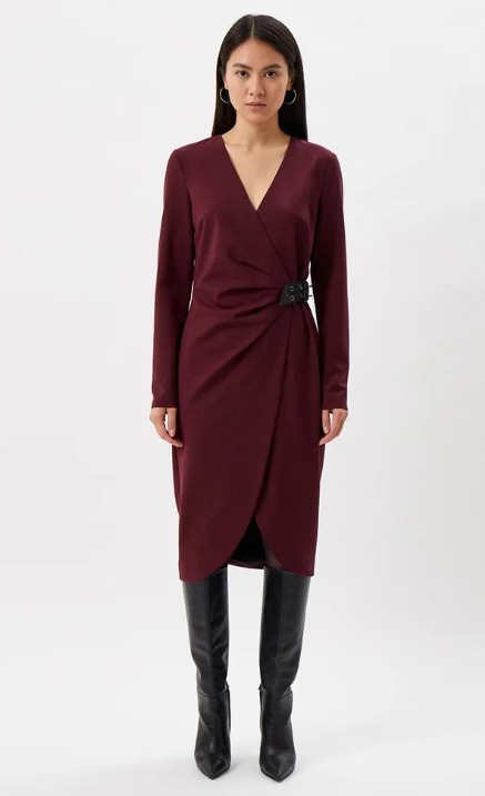 Front view of a model wearing the burgundy Patrizia Pepe draped sheath dress with long sleeves and a black waist buckle.